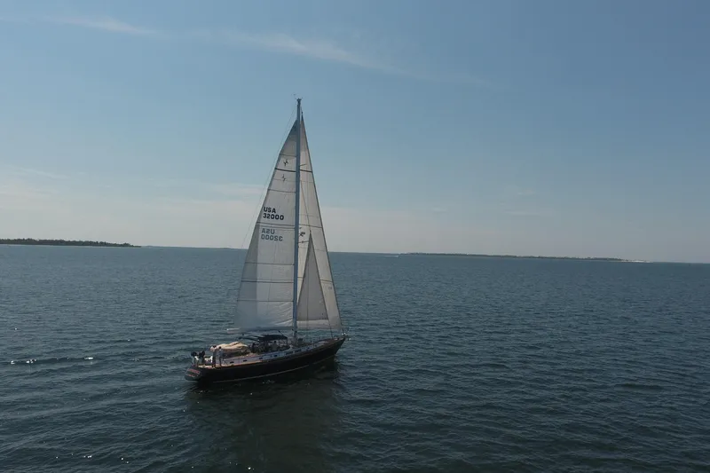 Slide: The Image of Sailing yacht Gulfstar 60 CC from 1981 on open sea under clear blue sky. - 26