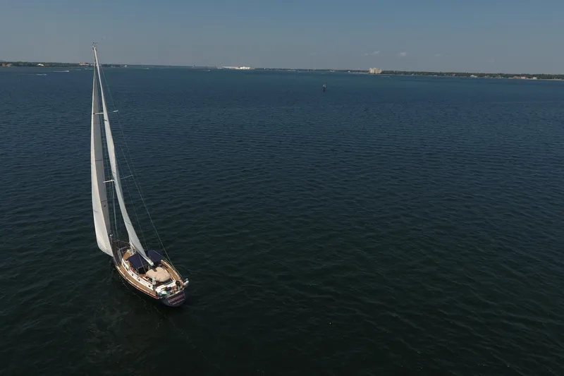 Slide: The Image of Sailing yacht Gulfstar 60 CC (1981) cruising on open water under clear skies. - 31