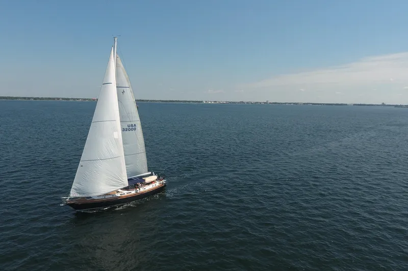 Slide: The Image of Sailing yacht Gulfstar 60 CC (1981) cruising on open water under clear skies. - 32