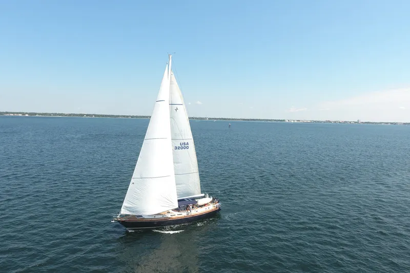 Slide: The Image of Sailing yacht Gulfstar 60 CC (1981) cruising on open water under clear skies. - 33