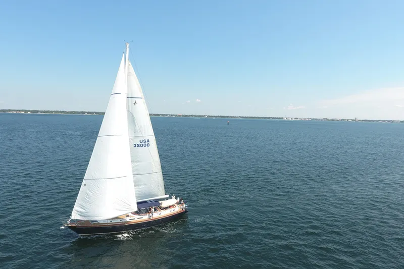 Slide: The Image of 1981 Gulfstar 60 CC sailboat cruising on open water under clear blue skies. - 34