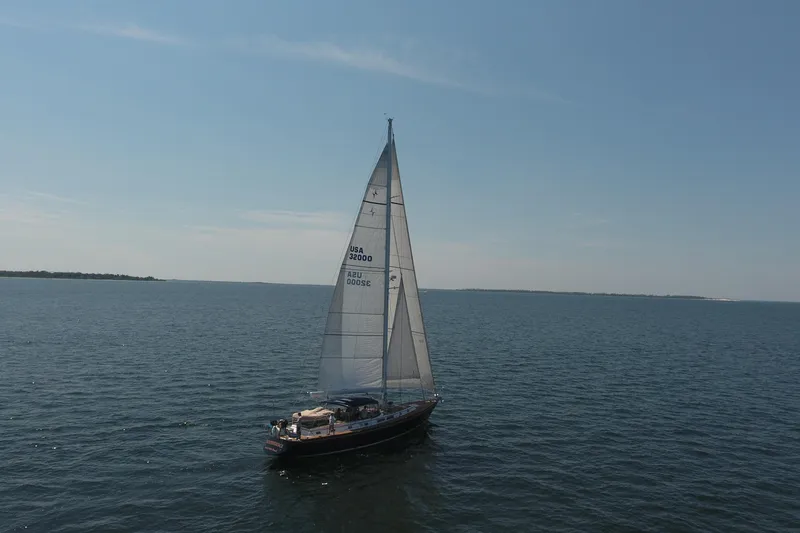 Slide: The Image of 1981 Gulfstar 60 CC sailboat cruising on open water under clear skies. - 4