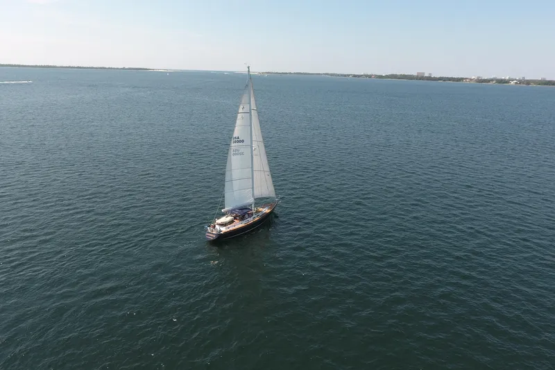 Slide: The Image of Sailboat Gulfstar 60 CC from 1981 cruising on open water under clear skies. - 5