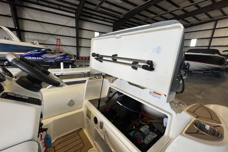 Slide: The Image of 2019 Zodiac Yachtline 400 interior with open storage compartment in a boat warehouse. - 11
