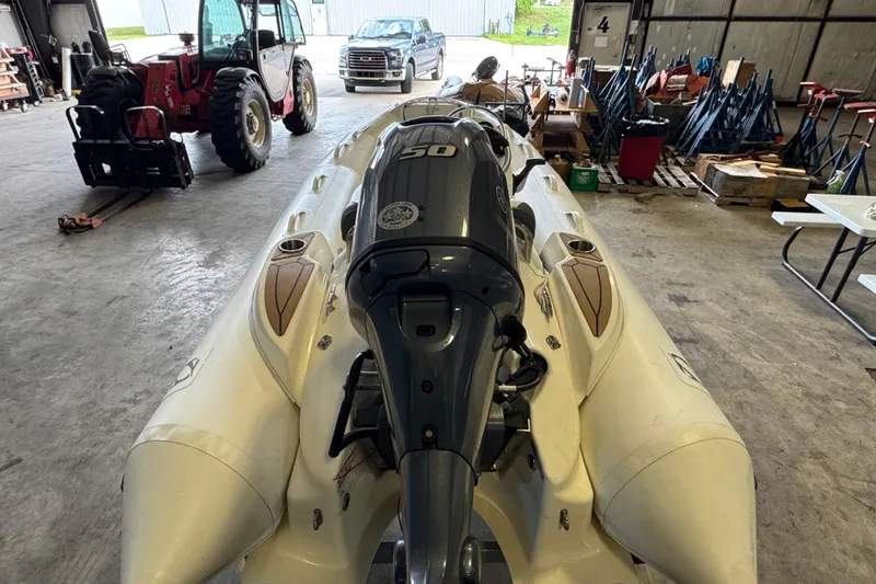 Slide: The Image of 2019 Zodiac Yachtline 400 inflatable boat with outboard motor in a storage facility. - 3