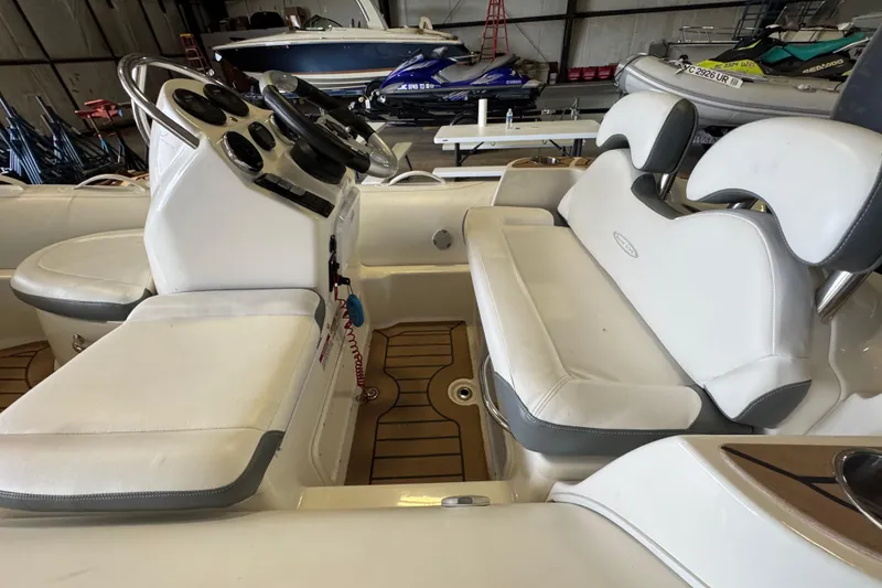 Slide: The Image of 2019 Zodiac Yachtline 400 interior with white seating and control panel in a storage facility. - 8