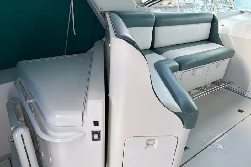 Slide: The Image of 1991 Trojan 12 Meter Express 400 interior with white and teal seating. - 5
