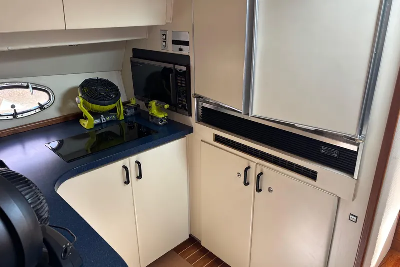 Slide: The Image of Interior of 1991 Trojan 12 Meter Express 400 yacht kitchen with appliances and counter. - 8