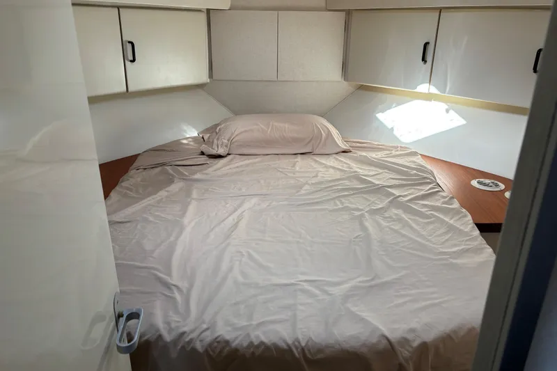 Slide: The Image of 1991 Trojan 12 Meter Express 400 cabin with bed and storage cabinets. - 9
