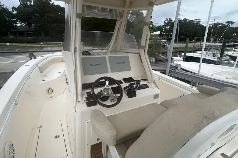Slide: The Image of 2016 Cobia 296 Center Console boat with Garmin navigation system at the helm. - 11