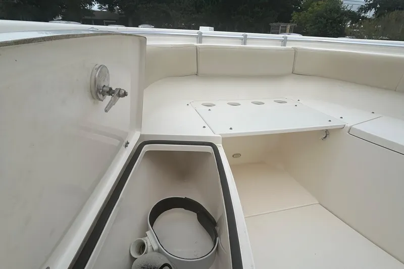 Slide: The Image of 2016 Cobia 296 Center Console boat interior with storage compartments and seating. - 16