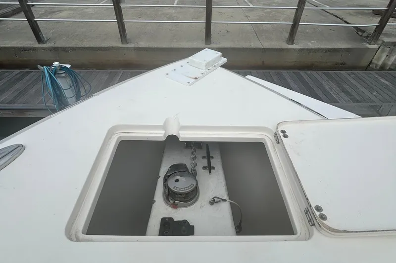 Slide: The Image of 2016 Cobia 296 Center Console anchor compartment at dockside. - 17