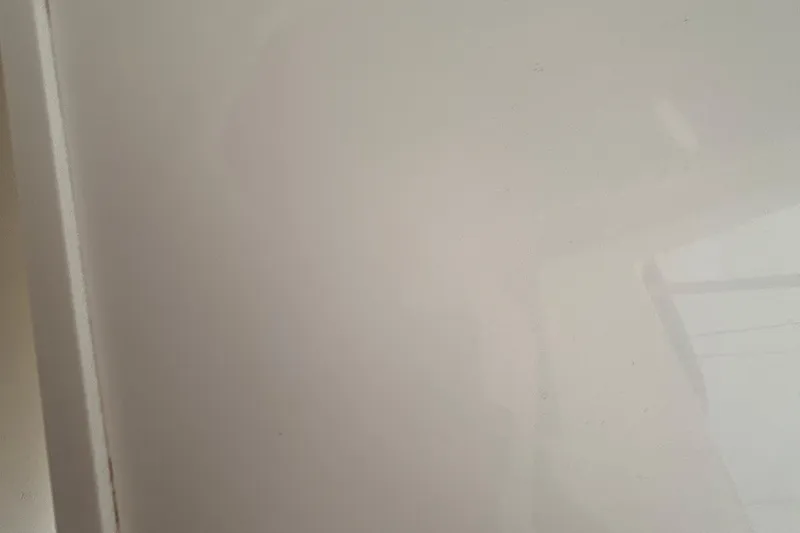 Slide: The Image of Blank white surface with subtle reflections, possibly a wall or panel. - 19