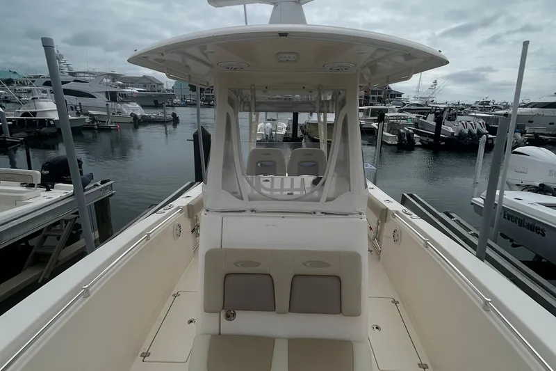 Slide: The Image of 2016 Cobia 296 Center Console boat docked at marina, overcast sky. - 22