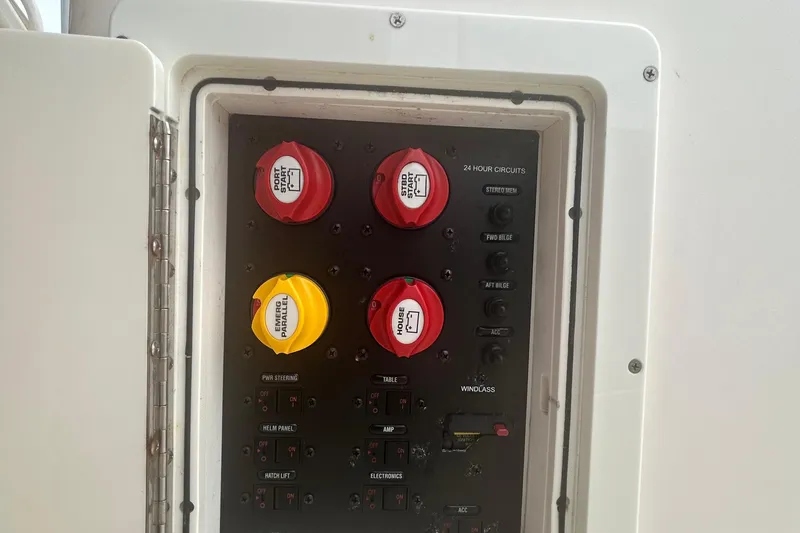 Slide: The Image of Electrical panel of a 2016 Cobia 296 Center Console boat with labeled switches and controls. - 26