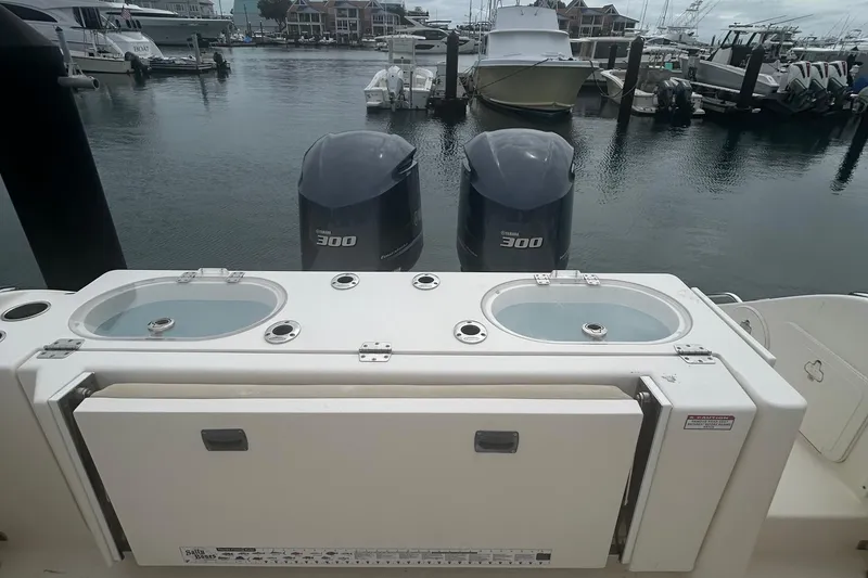 Slide: The Image of 2016 Cobia 296 Center Console boat with dual Yamaha 300 engines at marina. - 30