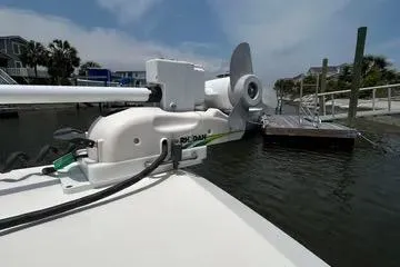 Slide: The Image of 2016 Cobia 296 Center Console boat with trolling motor at dock. - 39