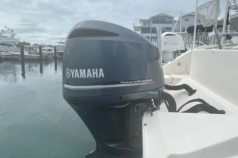 Slide: The Image of 2016 Cobia 296 Center Console with Yamaha four-stroke engine at marina. - 4