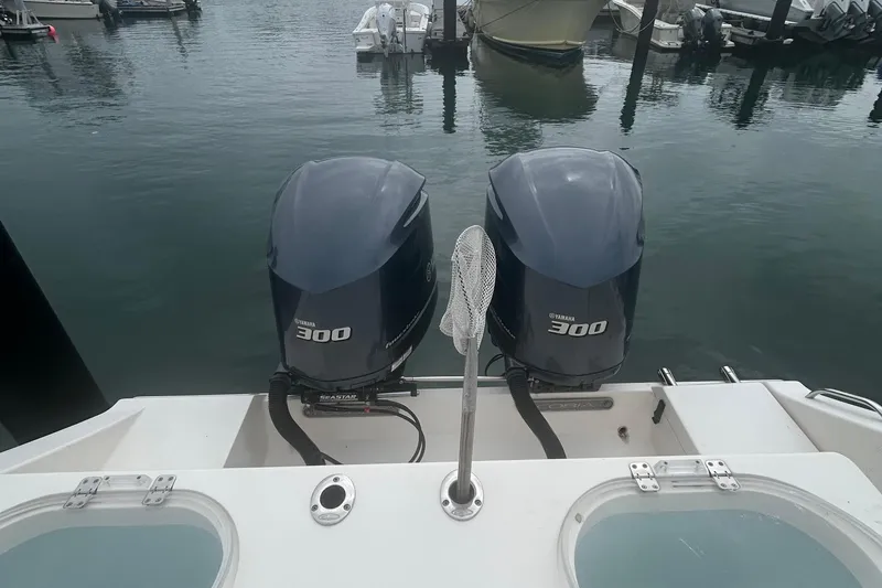 Slide: The Image of 2016 Cobia 296 Center Console with twin Yamaha 300 engines docked at marina. - 7