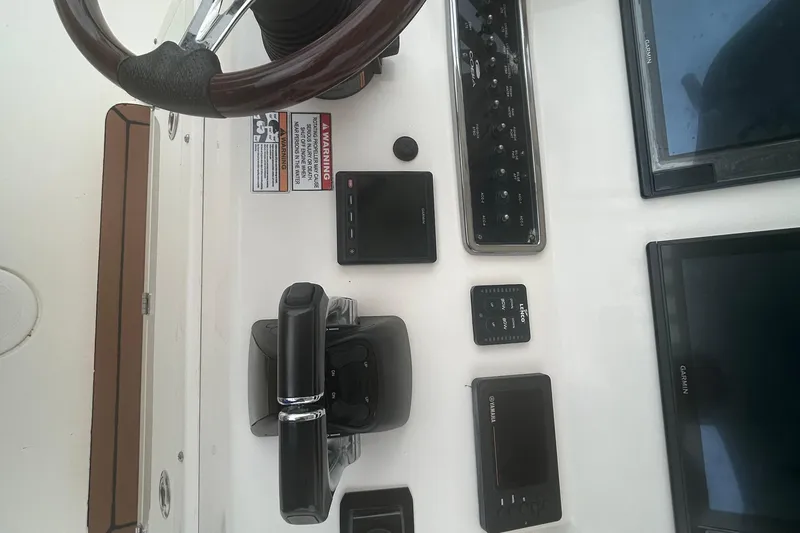 Slide: The Image of 2016 Cobia 296 Center Console dashboard with steering wheel and electronic controls. - 8