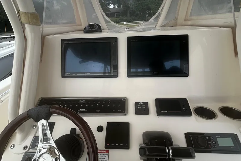 Slide: The Image of 2016 Cobia 296 Center Console dashboard with dual Garmin displays and steering wheel. - 9