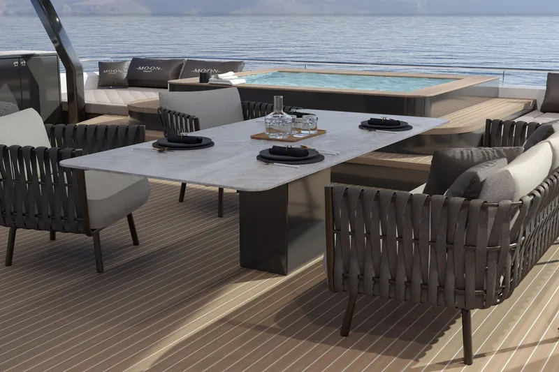 Slide: The Image of Luxurious yacht deck with dining table, chairs, and hot tub, Moon 9ty 2027 model. - 35