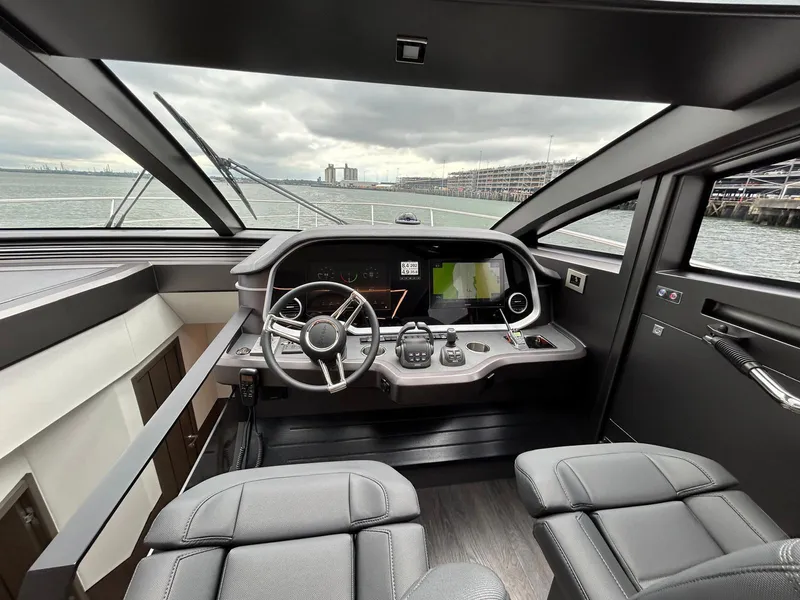 Slide: The Image of Luxurious interior of 2025 Pearl 63 yacht with modern dining and navigation area. - 12