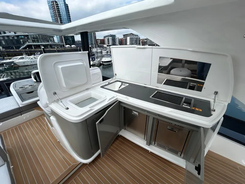 Slide: The Image of Luxurious interior of 2025 Pearl 63 yacht with modern seating and large window. - 31