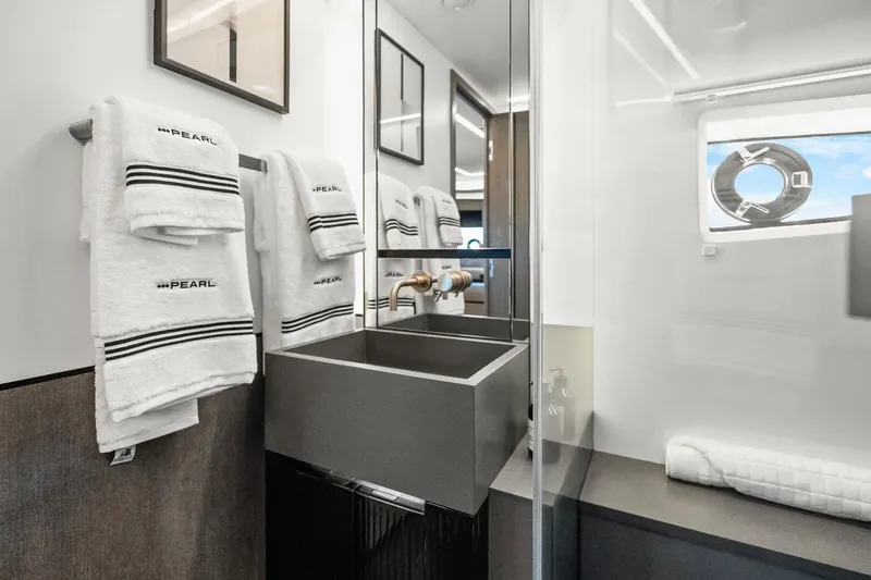 Slide: The Image of Luxurious bathroom in 2025 Pearl 63 yacht with modern sink and branded towels. - 46