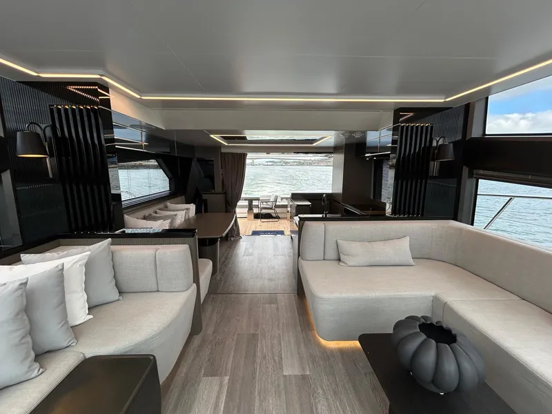 Slide: The Image of Luxurious 2025 Pearl 63 yacht cruising on open sea under clear blue sky. - 6