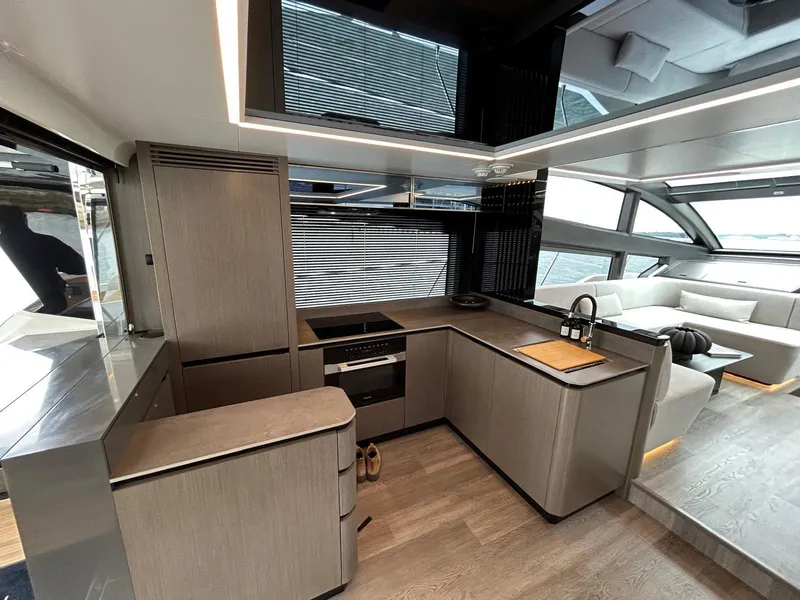 Slide: The Image of Luxury Pearl 63 yacht, 2025 model, cruising on open sea under clear blue sky. - 7