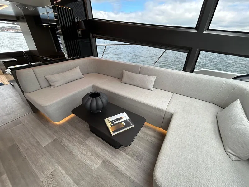 Slide: The Image of Luxurious 2025 Pearl 63 yacht with spacious deck, cruising on clear blue waters. - 9