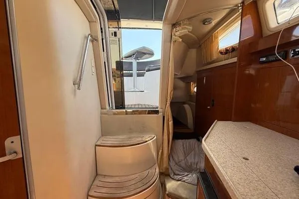 Slide: The Image of Interior of 2007 Regal 3060 Window Express boat, featuring steps and cabin area. - 11