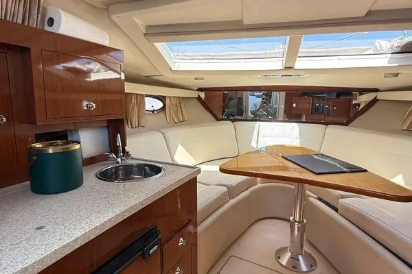 Slide: The Image of Luxurious interior of 2007 Regal 3060 Window Express yacht with seating and kitchenette. - 12