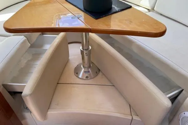 Slide: The Image of 2007 Regal 3060 Window Express interior with wooden table and cushioned seating. - 14