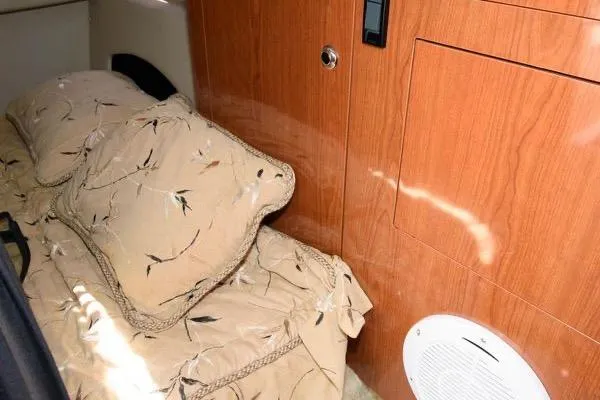 Slide: The Image of 2007 Regal 3060 Window Express cabin interior with beige bedding and wooden cabinetry. - 18