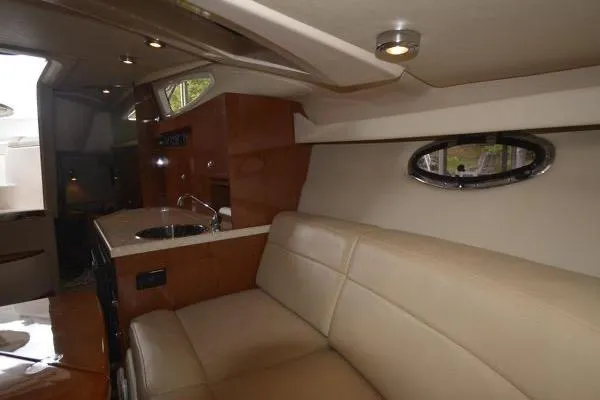 Slide: The Image of Interior of 2007 Regal 3060 Window Express yacht with beige seating and kitchenette. - 19