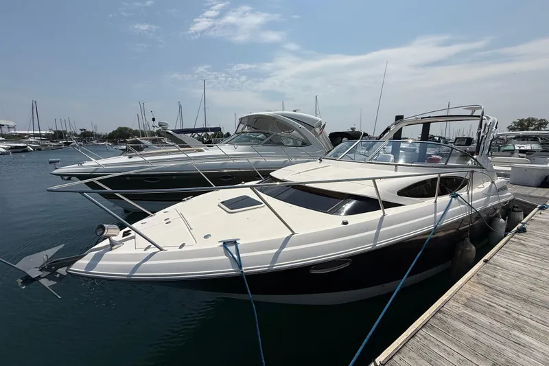 Slide: The Image of 2007 Regal 3060 Window Express boat docked at marina under clear sky. - 2