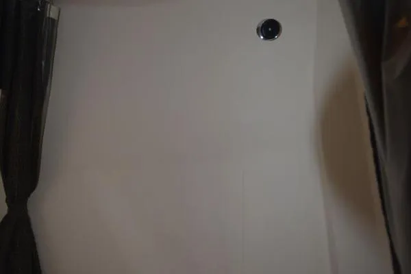 Slide: The Image of Interior view of 2007 Regal 3060 Window Express boat, featuring a white wall and curtain. - 23