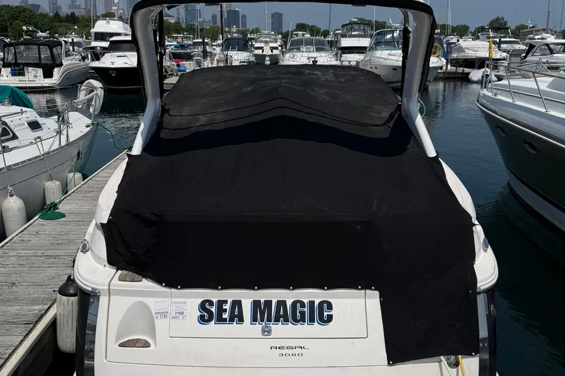 Slide: The Image of 2007 Regal 3060 Window Express boat named "Sea Magic" docked at a marina. - 4