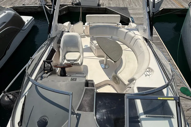 Slide: The Image of 2007 Regal 3060 Window Express boat interior with seating and steering wheel at dock. - 5