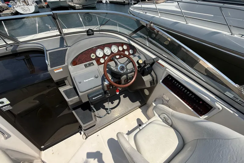 Slide: The Image of 2007 Regal 3060 Window Express boat cockpit with steering wheel and control panel. - 6
