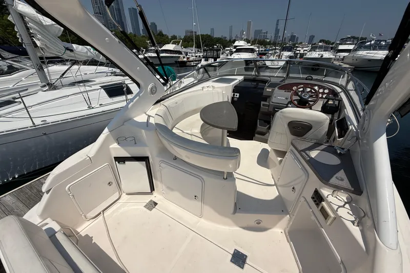 Slide: The Image of 2007 Regal 3060 Window Express boat interior with seating and control panel at marina. - 7