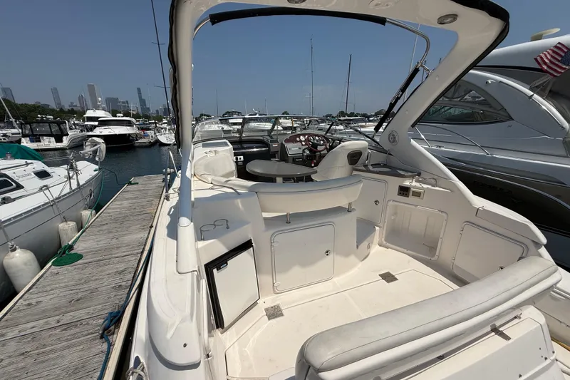 Slide: The Image of 2007 Regal 3060 Window Express yacht interior at marina, showcasing helm and seating area. - 8