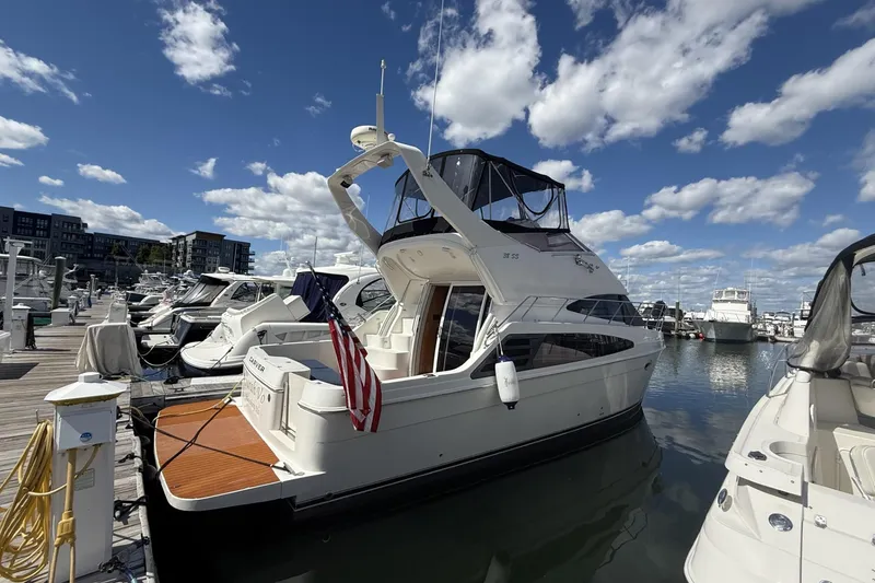 The Image of 2006 Carver 38 Super Sport yacht docked at marina under blue sky. - 0