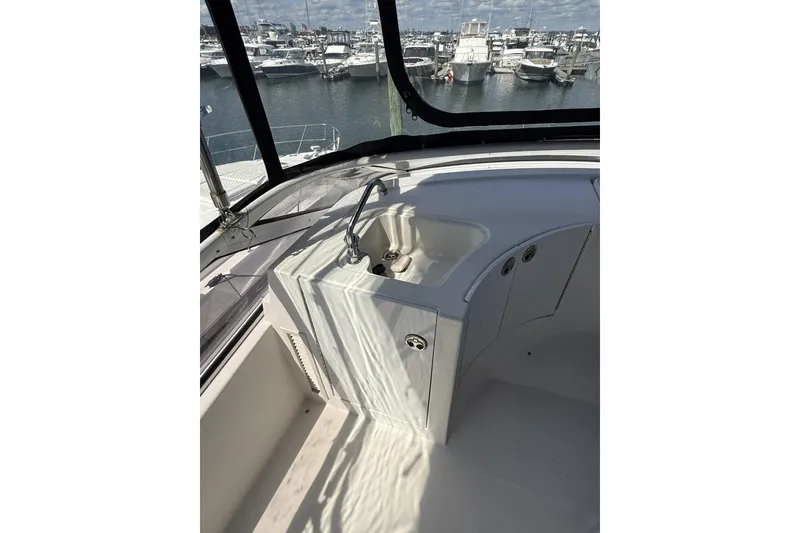 Slide: The Image of 2006 Carver 38 Super Sport yacht interior with sink, marina view in background. - 10
