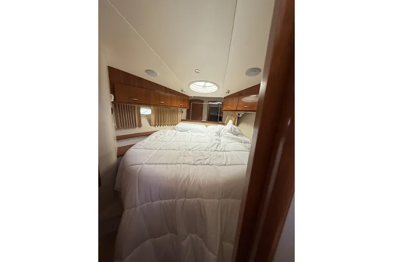 Slide: The Image of Interior cabin of 2006 Carver 38 Super Sport yacht with cozy bed and wooden accents. - 13