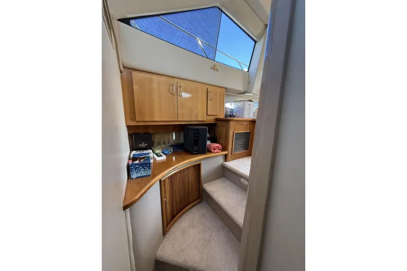 Slide: The Image of Interior of 2006 Carver 38 Super Sport yacht with wooden cabinets and carpeted stairs. - 14