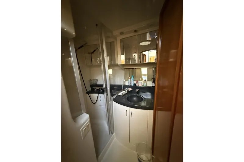 Slide: The Image of 2006 Carver 38 Super Sport yacht bathroom with sink, mirror, and toiletries. - 15