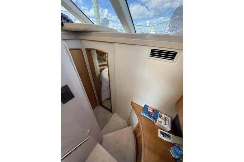 Slide: The Image of Interior of 2006 Carver 38 Super Sport yacht, featuring stairs and a cozy cabin. - 16